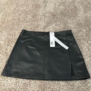 Topshop faux leather black mini skirt with slit. US 4. Brand new with tags